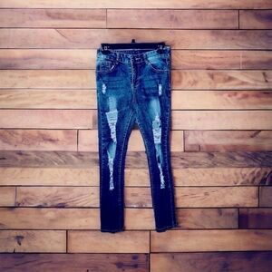 Ripped, distressed, denim jeans.